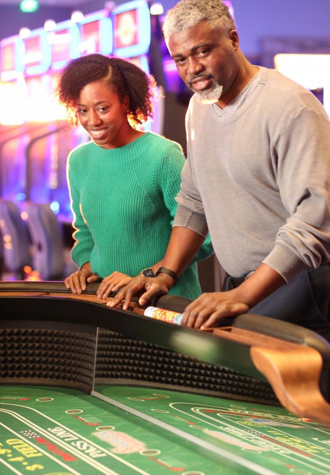 Couple at the craps table at Saracen Casino Resort.